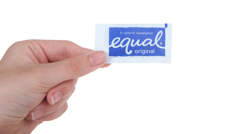 Hand holding Equal packet