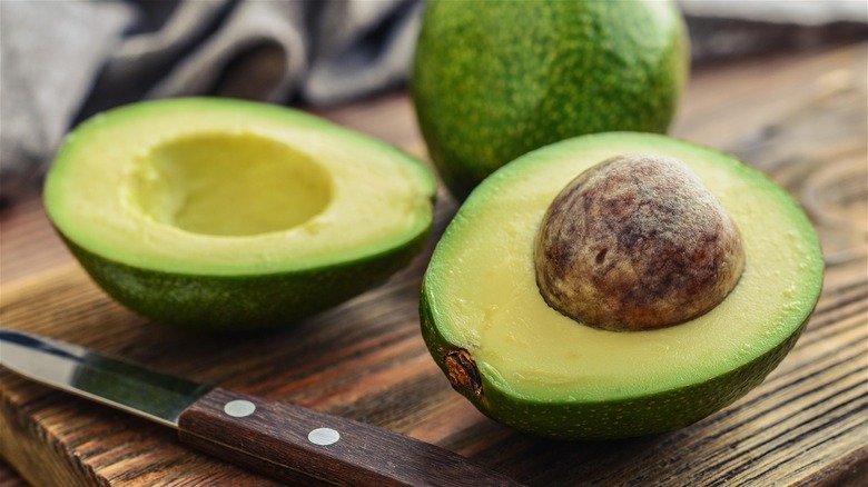 Sliced avocado on wooden cutting board