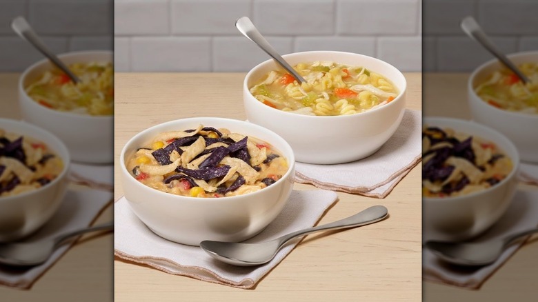 Chick-fil-A's chicken noodle and chicken tortilla soups in small white bowls