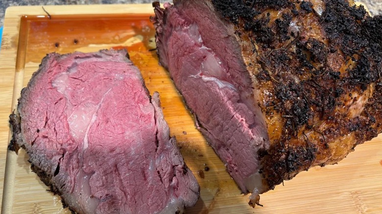 A cooked and sliced prime rib from Costco on a wooden cutting board