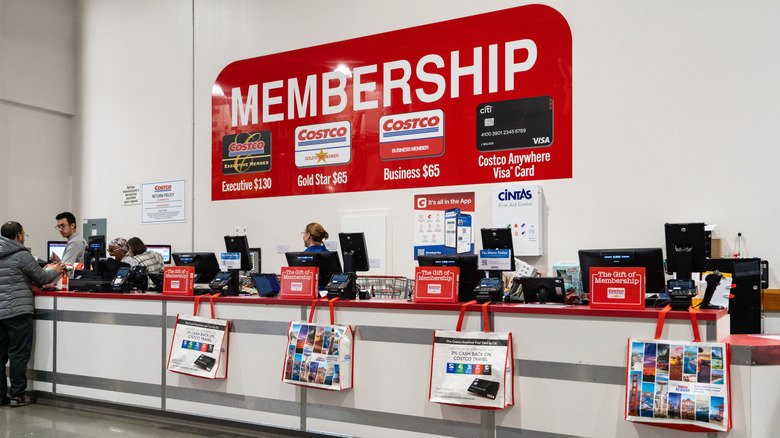 Costco membership cards sign over cash registers