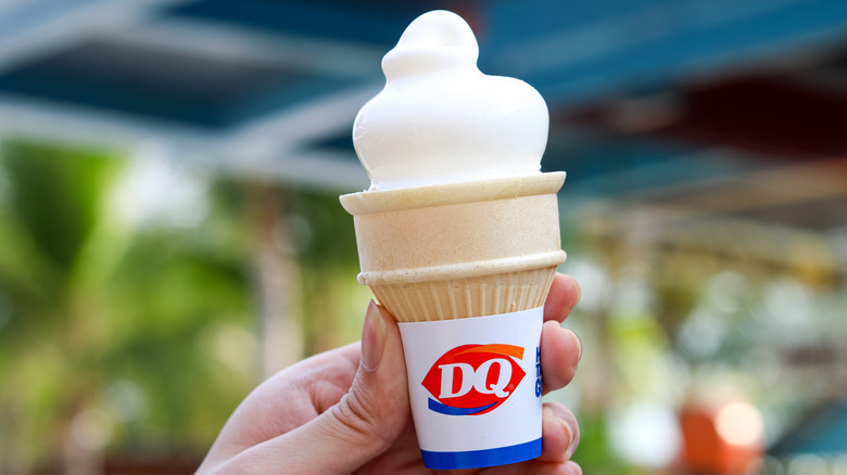 Hand holding up a Dairy Queen soft-serve cone