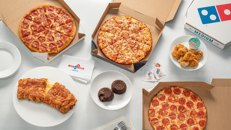 domino's pizzas, chicken, cheesy bread, and cake