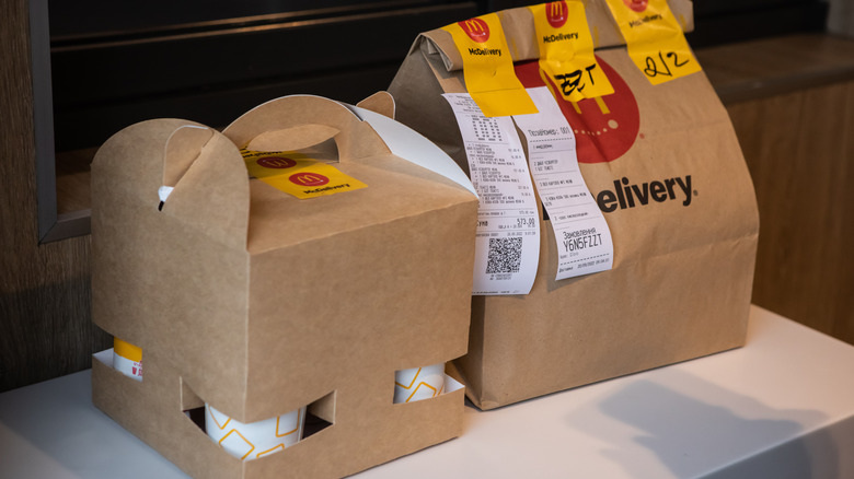 McDonald's food and takeout drinks in cardboard holders and bags ready for delivery