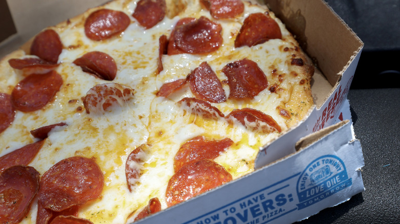 closeup of a Domino's pepperoni pizza in takeout box