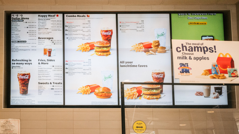 a McDonald's digital menu screen behind counter