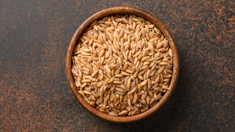Wooden bowl of farro on table