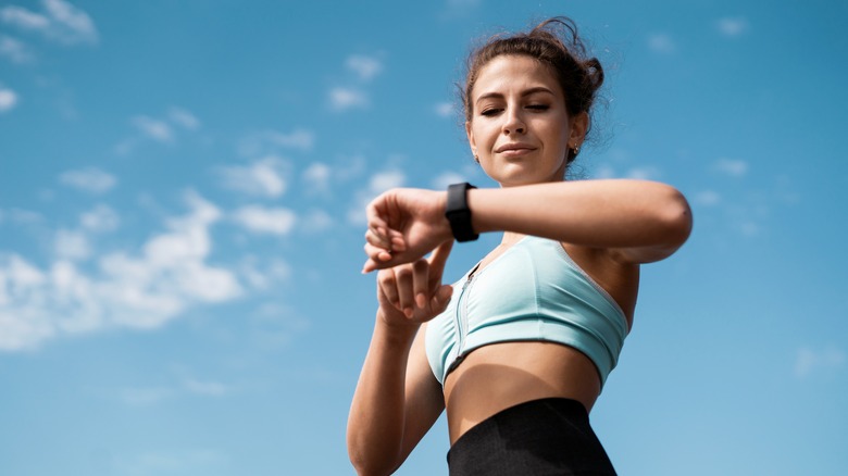woman checking watch outside