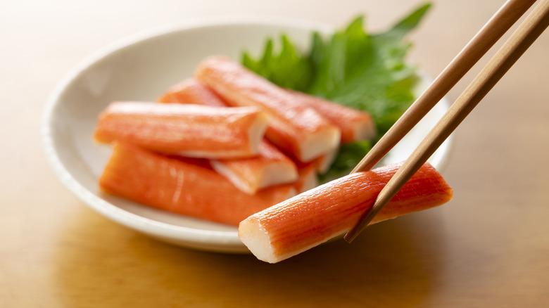 Chopsticks holding imitation crab meat