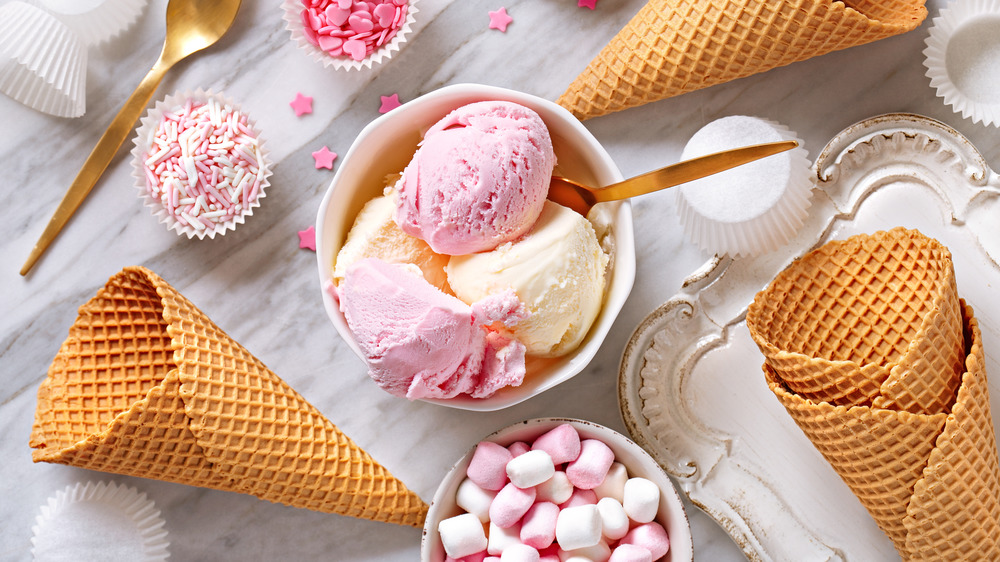 Ice cream in a bowl with cones and toppings