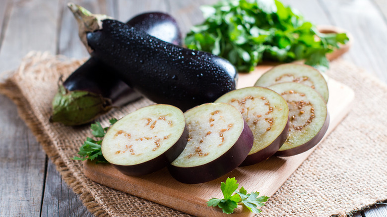 Sliced eggplants on cutting board