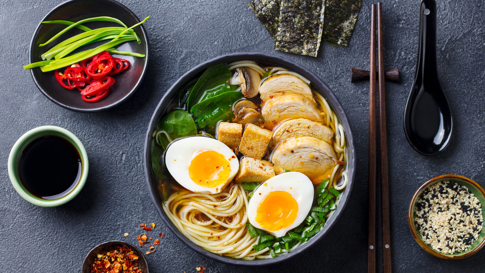 A bowl of ramen with sides