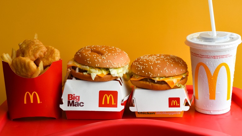 McDonald's drink, fries, and burgers with packaging