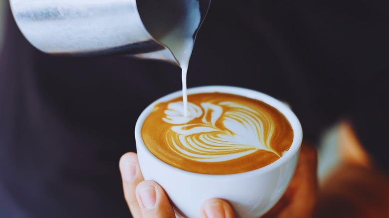 Barista pouring latte art