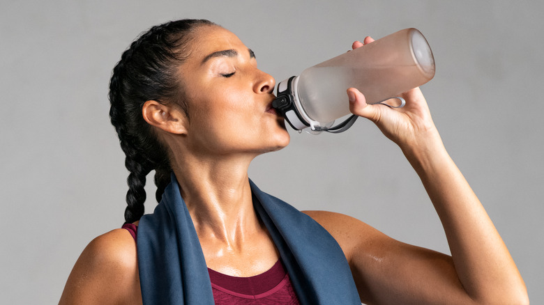 Woman drinking from bottle of water