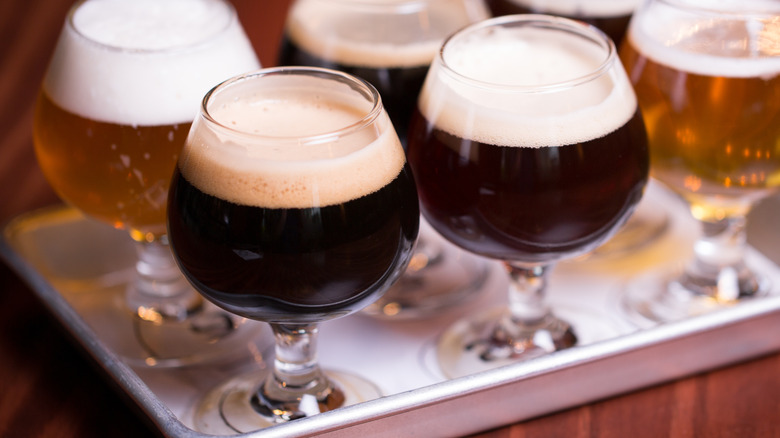 Craft beer flight with six full glasses on metal tray