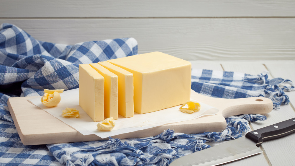 Stick of butter on cutting board