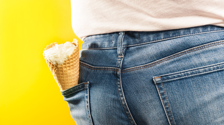 Person with an ice cream cone in the back pocket of their jeans