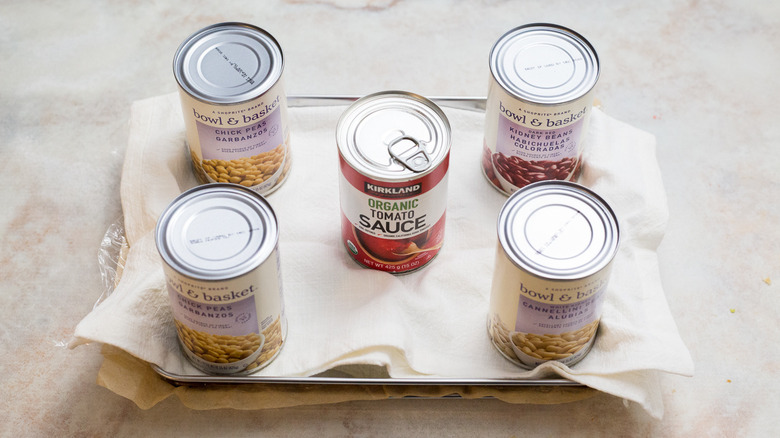 cans weighing down sheet pan