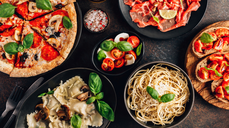 Pasta, pizza and Italian dishes on table