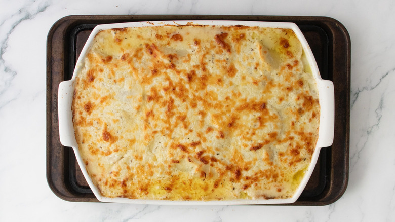 Baked scalloped potatoes in casserole dish
