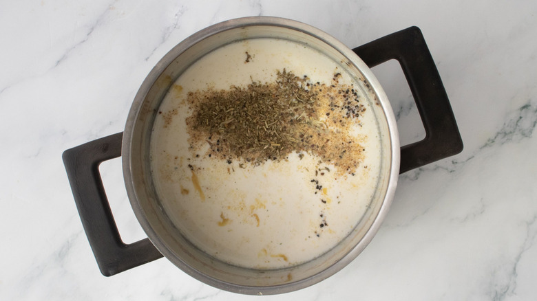 Milk and seasonings in saucepan