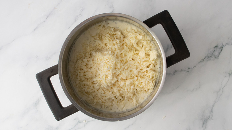 Shredded cheese in saucepan