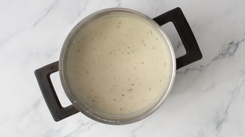 Creamy sauce in saucepan