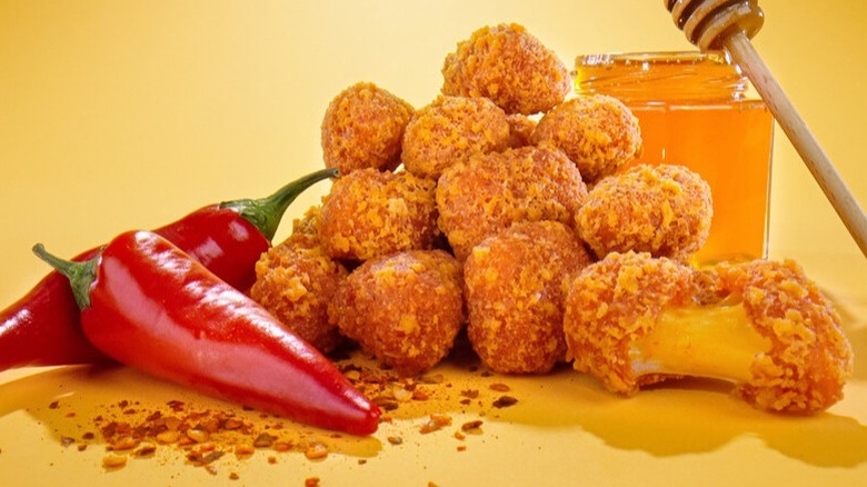 Hot honey curds piled between red chilis and honey