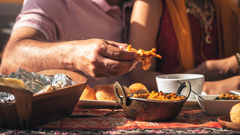 person eating food with hands