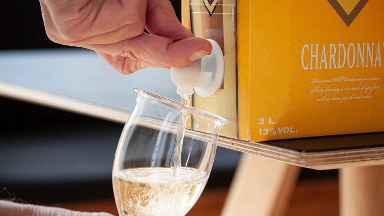 Pouring white wine from box