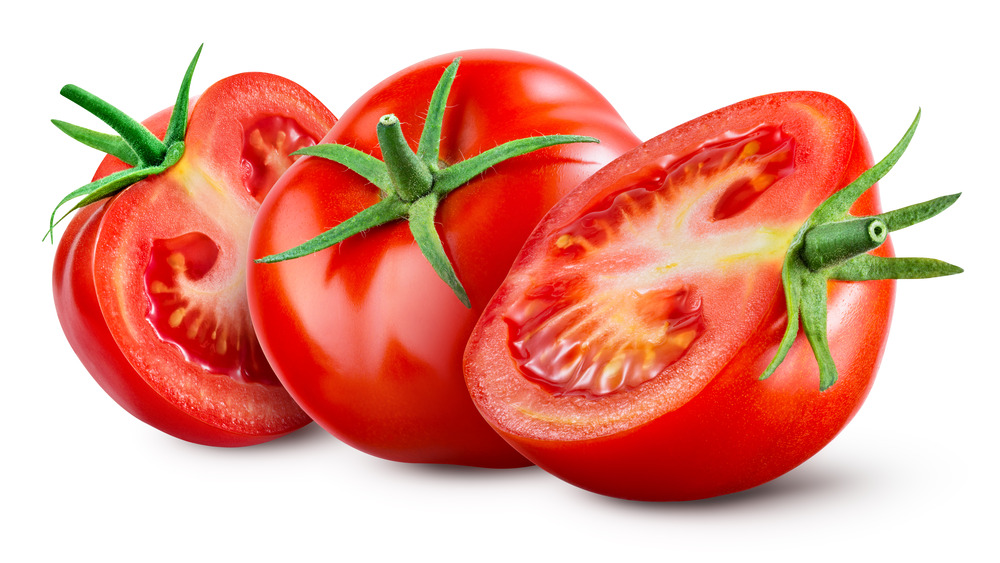 Three sliced tomatoes with stems