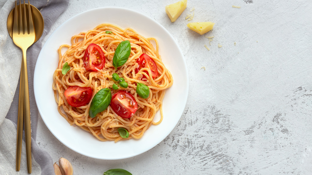 Bowl of pasta with tomatoes and basil 