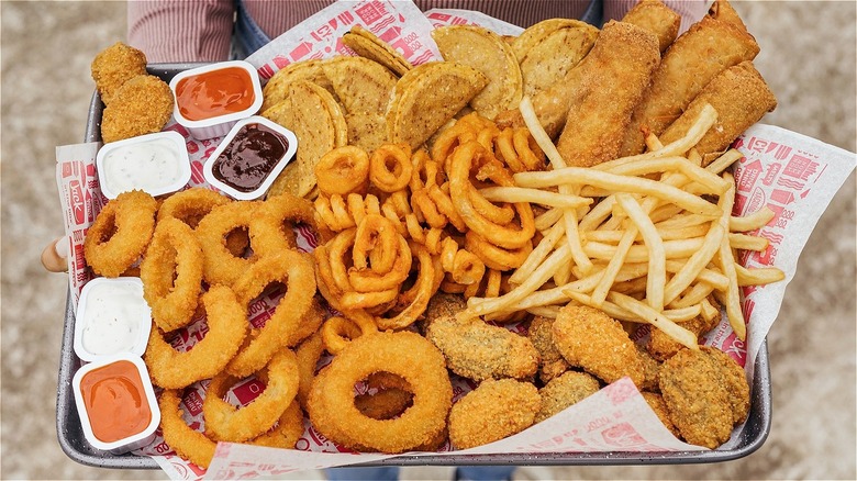Tray of Jack in the Box snack menu items, including tiny tacos, egg rolls, onion rings, fries, and curly fries