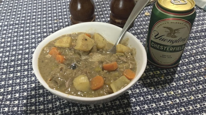 Bowl of squirrel soup with a can of beer