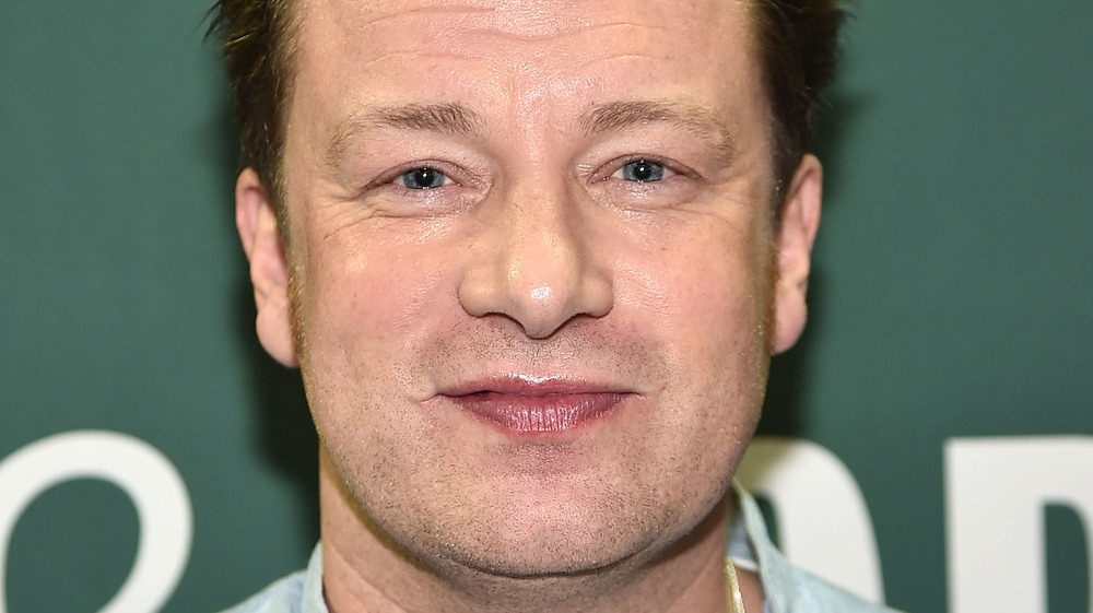 Jamie Oliver against green background