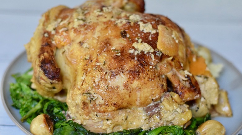 whole roasted chicken on bed of spinach