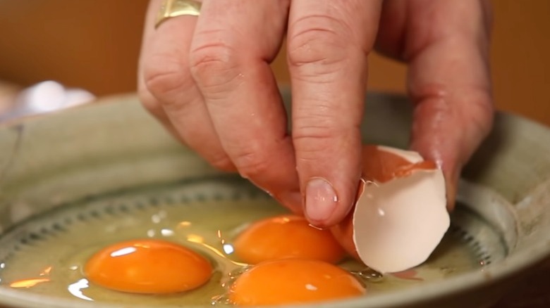 use the eggshell to scoop out shell fragments in the bowl