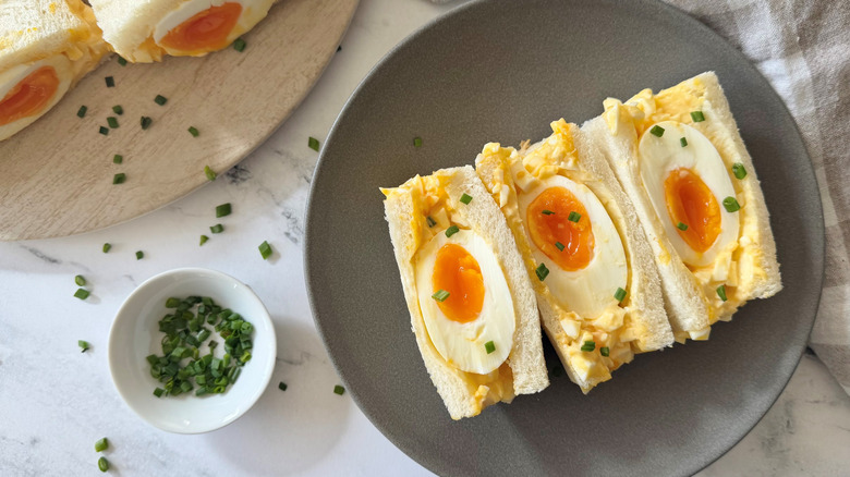 Japanese egg salad sandwiches face up with jammy eggs in middle