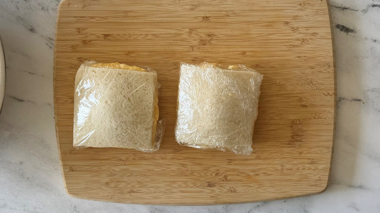 Crustless egg salad sandwiches wrapped in plastic