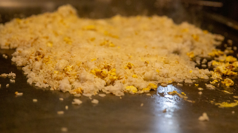 Rice frying on an iron griddle