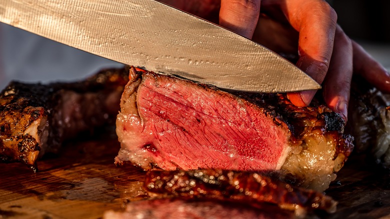 cutting into a steak
