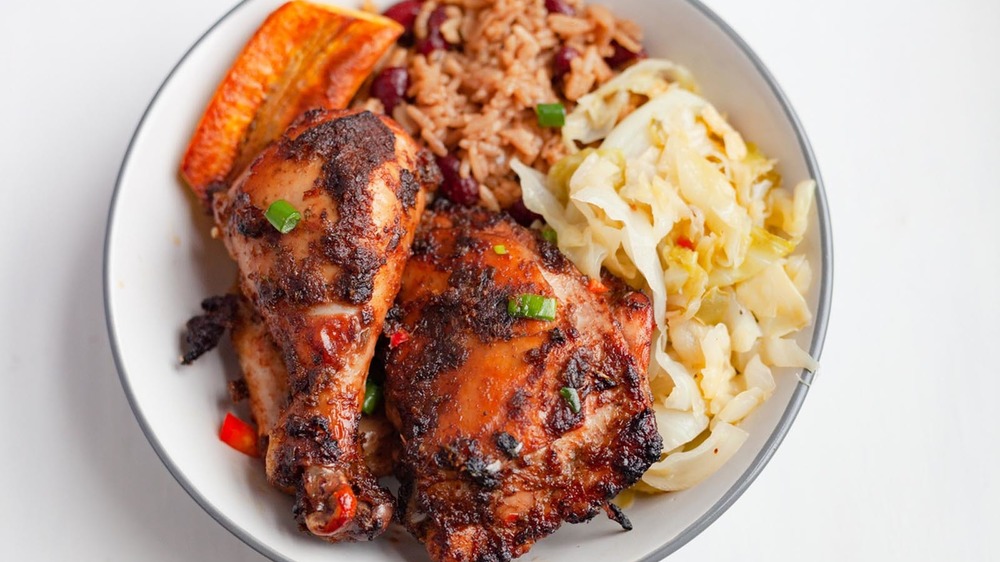 Jerk chicken on a plate with sides