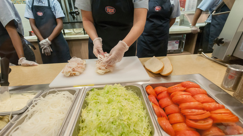 Jersey Mike's employee assembling sandwiches