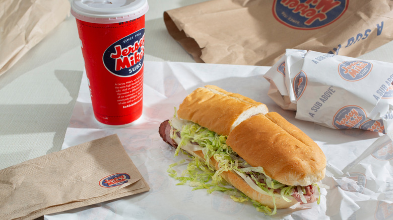 Jersey Mike's sandwich and drink with napkins.