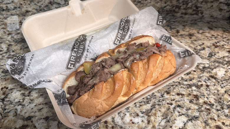 Firehouse subs steak and cheese melt in takeout box on counter