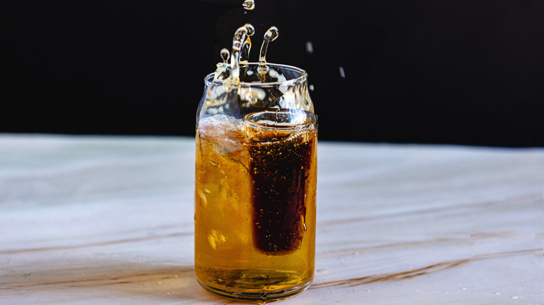 shot glass splashing in cup 