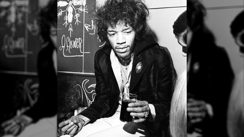 Jimi Hendrix holding a glass