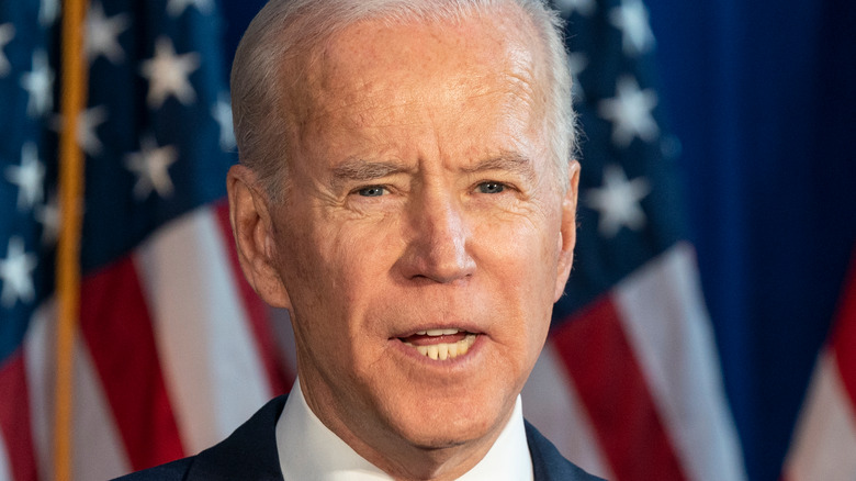 Joe Biden speaking in front of American flag