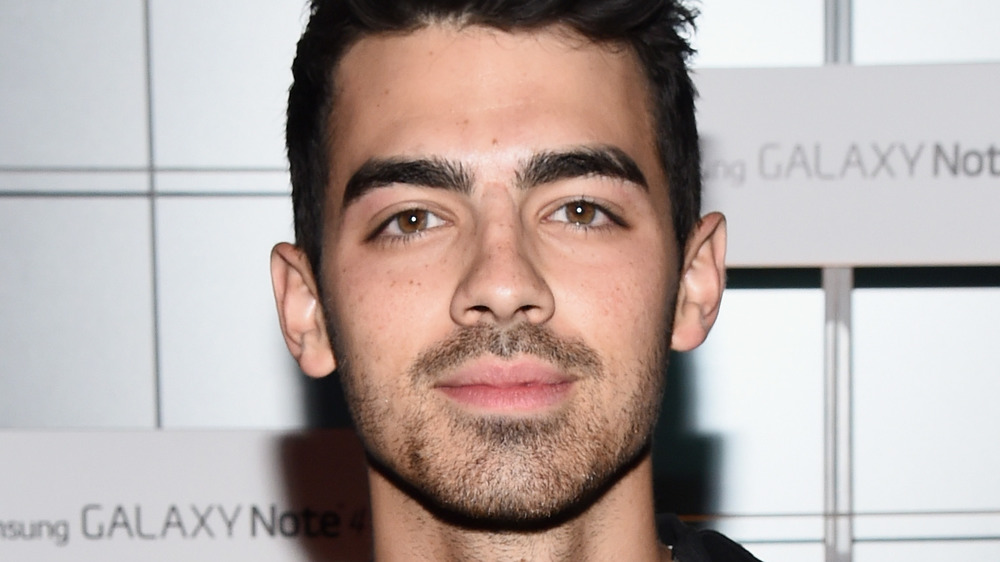 Joe Jonas smiling at event